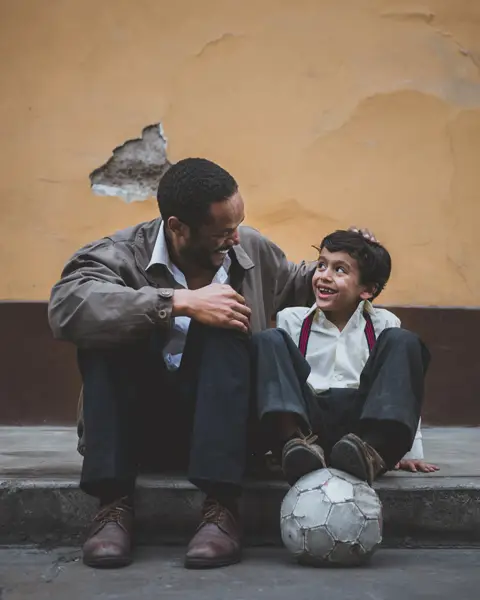 Adult and child having a conversation. They are paying attention to each other.